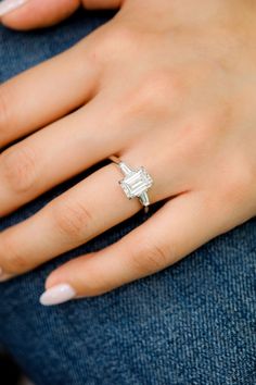 a woman's hand with a diamond ring on it