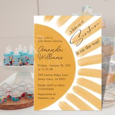 a baby shower party is set up on a table with bottles and cake in the background