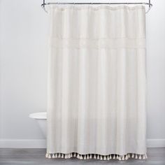 a white shower curtain in a bathroom