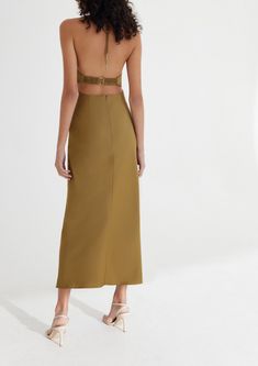 Designed by Significant Other. Crafted with the event season in mind, the Alix Dress in Olive is designed to be fitted through the bodice and drape elegantly toward the hem. Halter neckline with front cut out detail, gathered fabrication at the waist with luxe gold hardware polishing off this elegant silhouette. Fit: Model is 180cm / 5′10″ wearing an AU 8 / US 4 Materials + Care: 62% Viscose Rayon, 38% Polyester. This fabric has been specially woven. Because of its delicate design and characteri Elegant Gold Ruched Midi Dress, Chic Ruched Dress With Cut-out Waist, Formal Backless Midi Dress With Ruched Bodice, Chic Evening Dress With Ruched Bodice, Chic Maxi Dress With Cutout Back For Gala, Elegant Gala Dress With Cutout Back, Chic Backless Ruched Dress With Fitted Bodice, Chic Ruched Backless Dress With Fitted Bodice, Party Midi Dress With Cutout Back And Waist