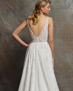 a woman in a white wedding dress standing back to back