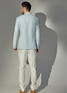 Presenting the stunning Light Blue Bandhgala Jacket Set, crafted from a premium wool blend that exudes elegance and modern sophistication. The blue bandh gala, designed with a textured finish, features a sleek mandarin collar and a buttoned front, offering a refined, tailored look. Paired with off-white trousers, this ensemble strikes the perfect balance between tradition and contemporary fashion. Its versatile color and high-quality material ensure both comfort and durability, making it a must- Winter Blue Bandhgala For Formal Events, Fitted Stand Collar Blazer For Semi-formal Occasions, Fitted Blazer With Stand Collar For Semi-formal Occasions, Fitted Stand Collar Blazer For Semi-formal, Elegant Blue Blazer With Stand Collar, Elegant Blue Stand Collar Blazer, Tailored Spring Tuxedo, Tailored Long Sleeve Spring Tuxedo, Tailored Bandhgala With Stand Collar For Formal Occasions