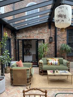 a living room filled with furniture under a glass roof