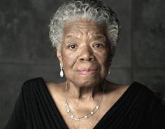 an older woman wearing a black top and pearls