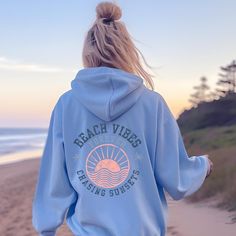 Embrace the retro summer vibes with our Beach Vibes Forever Chasing Sunsets hoodie, perfect for the eternal sunset chaser in you! This trendy unisex sweatshirt is designed for the summer lover who can't resist the allure of chasing sunsets at the beach. The words Forever chasing on the back add a cool and laid-back touch, making it a must-have for any surfer or sunset lover. Made with a cozy blend of cotton and polyester, this hoodie will keep you warm and stylish no matter the weather. Get ready to rock the retro beach look with this summer-saying sweatshirt that exudes endless summer vibes. Designed with style and comfort in mind, this hoodie will quickly become your new favorite. It's made from soft fleece inside and outside, with a sturdy metal zipper, convenient front pockets, and a h Summer Vacation Cotton Hoodie, Cotton Hoodie For Summer Vacation, Blue Hooded Tops For Beach, Blue Hooded Beach Tops, Blue Hooded Top For Beach, Blue Hooded Tops For The Beach, Summer Casual Hoodie With Letter Print, Summer Hoodie Sweatshirt With Letter Print, Summer Letter Print Hoodie Sweatshirt