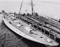 an old black and white photo of a boat docked