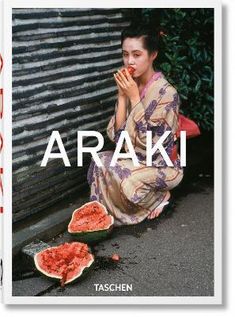 a woman sitting on the ground next to watermelon