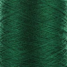 green yarn spools on a white background