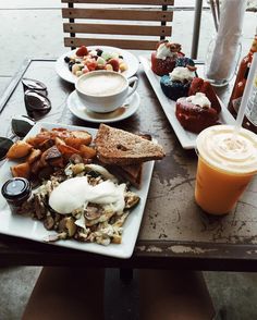 a table topped with plates of food and drinks