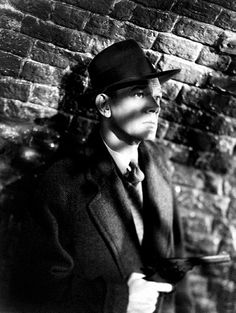 black and white photo of a man wearing a top hat