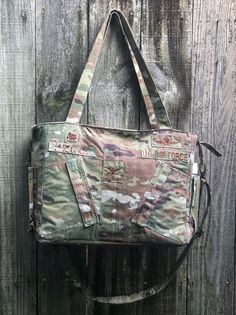 "Diaper Bag, Large Military Nappy Bag, Messenger Bag, Computer Bag, Laptop Bag, Military Tote, Flight Suit Diaper Bag Talk about room . . . this large Recycled Military Diaper Bag has ample space for all of your little one's many essentials! Made from your soldier's recycled uniform, flight suit, bdu, acu, etc. Oversized inside lining pockets, two sides and a large back pocket. Outside pockets were transferred from uniform. Sturdy sport zipper for top closure. The two handles as well as a remova Duffle Tote Bag With Removable Pouch For Shopping, Shopping Duffle Bag With Removable Pouch, Canvas Backpack With Top Carry Handle, On-the-go Duffle Bag Tote With Pockets, On-the-go Shoulder Duffle Bag With Pockets, On-the-go Tote Bag With Pockets, Weekender Shoulder Bag With Removable Pouch, Weekender Shoulder Bag With Top Carry Handle, Everyday Tote Duffle Bag With Pockets