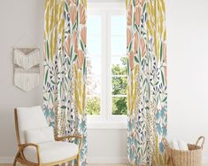 a living room with a chair, rug and window curtain in front of the window