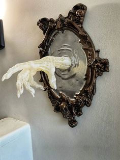 a wall mounted mirror with a light on it