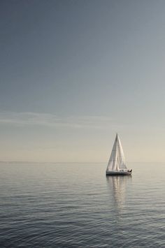 a sailboat floating on top of a large body of water