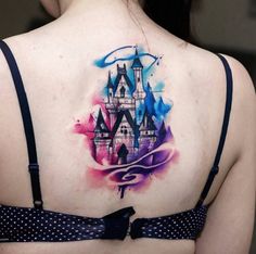 a woman with a castle tattoo on her back