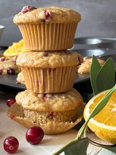 three muffins stacked on top of each other with cranberries and orange slices