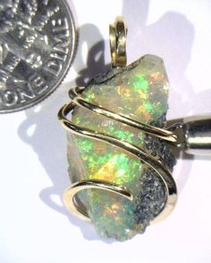 15.61ct African Crystal Opal in 14kt Gold Art Wire Wrap Pendant 15.61 carats total weight DON'T MISS OUR OTHER AUCTIONS & EBAY STORE! Total weight 15.61 carats including wrap Size 26 mm by 13 mm by 11 mm including wrap Up for sale is a beautiful natural African opal artfully wrapped in a 14kt gold tension wire wrap. This stunning piece is beyond compare and the pictures hardly do it justice. The glowing stone is radiant with flashes of green, yellow, and red fire that consume the entire piece jumping out at the eye with the slightest movement. To top it off are the swirling waves of glowing 14kt gold that securely grasp the stone and set it off to perfection. The perfect piece for any collection! Wire wrapping or Wire sculpture is one of the oldest techniques for making jewelry by hand. Bu Luxury Untreated Jewelry For Gift, Luxury Untreated Jewelry As A Gift, Untreated White Gold Jewelry For Formal Occasions, Luxury Untreated Jewelry For Anniversary, Unique Untreated Yellow Gold Jewelry, Artisan Jewelry Necklaces, Art Wire, Handcrafted Artisan Jewelry, Gold Art