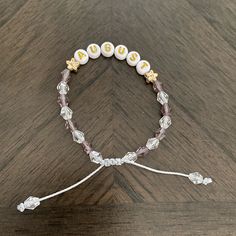 a beaded bracelet with the word jesus written on it and beads attached to it