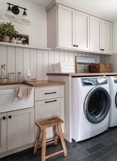 a washer and dryer sitting in a kitchen next to a counter top oven