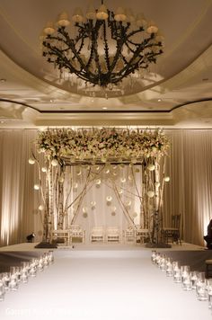 an elegant wedding setup with candles and chandelier