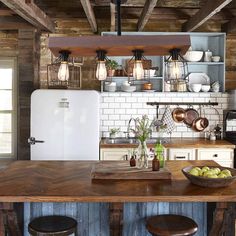 an old fashioned kitchen with wooden floors and exposed ceilings, white appliances and open shelving