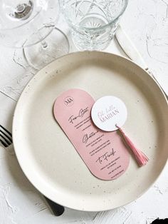 a plate with two pink tags on it