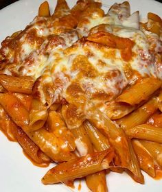 pasta with cheese and sauce on a white plate