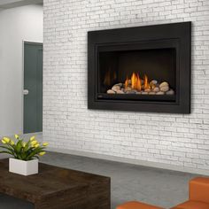 a white brick wall with a fireplace in the middle and yellow flowers on the other side