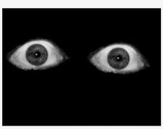 an image of two eyes in the dark