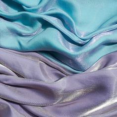 the fabric is blue and purple with silver foiling on it's edges, as well as other material