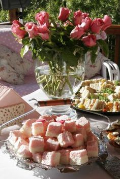 a table topped with lots of different types of desserts and pastries on top of plates