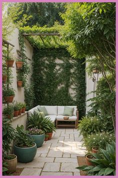 an outdoor seating area with potted plants and greenery on the walls, along with a couch