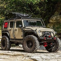 an off - road vehicle parked on the side of a mountain