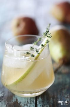 an apple cider is garnished with fresh herbs