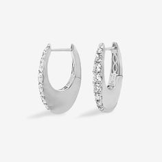 Skillfully crafted, these elegant U-hoop earrings boast prong-set round brilliant-cut diamonds. With its contemporary solid gold design, this hoop offers a flawless touch of luxury in white or yellow gold. Curate an eye-catching statement look by matching this with some of the other natural beauties from our Diamond Jewelry Collection. Natural Diamonds: 0.60ctw 14K White or Yellow Gold Length: 3/4 Inch Luxury White Diamond-cut Hoop Earrings, Diamond Hoop Earrings, Gold Design, Round Brilliant Cut Diamond, Brilliant Cut Diamond, Round Brilliant, Prong Setting, Diamond Jewelry, Natural Diamonds