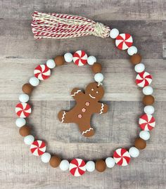 a wooden beaded necklace with a gingerbread cookie and candy canes on it