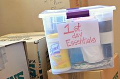 a plastic container filled with lots of items next to cardboard boxes and other packaging on the floor