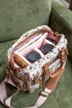 an open purse sitting on top of a green couch