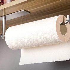 a roll of toilet paper hanging from a shelf