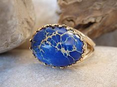 Blue Jasper Ring, Blue Gemstone ring, 14K Gold Filled Ring, Gold Oval Gemstone Ring, Women's Gold Statement Ring, Genuine Jasper Stone RingGold filled blue jasper ring, It will be a perfect women's gift.Metal: 14K Gold Filled / 925 Sterling SilverSize- all USGemstone: JasperStone Size: 18mmx13mmPlease allow 4-5 days to prepare. I usually ship earlier than this.If you are in a rush, please let me know.The ring will be packed in a gift box.FOR MY RINGS COLLECTION HERE:https://www.etsy.com/il-en/sh Oval Yellow Gold Rings With Natural Stones, Oval 14k Gold Rings With Natural Stones, 14k Gold Blue Oval Cabochon Rings, Blue 14k Gold Oval Cabochon Rings, 14k Gold Jewelry With Large Oval Stone, Oval Blue Opal Ring In 14k Gold, Blue Oval Opal Ring With Natural Stones, Aquamarine Gold Ring, Navy Blue Earrings