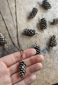 I live in upstate NY, and pinecones are everywhere🌲 The main purpose of a pinecone is to keep the seeds of the tree safe, which is why it is shaped with it's scales closely in and down. As with most things in nature, they're beautiful and perfectly designed This pendant is made out of antique brass and copper. Up close, it's very realistic looking and larger than the other designs I've seen on Etsy. The pendant measures about 2 inches in height and looks amazing on a long chain so you can fidge Three Pines Gifts, Pine Cones Jewelry, Silver Pines Gifts, Necklaces For Nature, Real Pinecone Earrings, Pine Needle Ring, Pine Cone Necklace, Pine Cone Jewelry, Pinecone Necklace