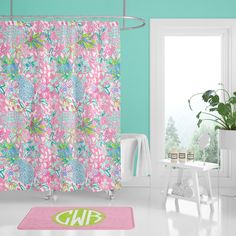 a bathroom with a pink shower curtain and rug