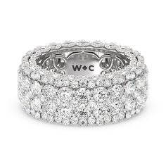 a white gold and diamond ring with three rows of round brilliant cut diamonds in the center