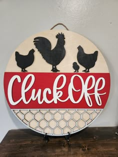 a red and white sign that says click off with chickens on the bottom of it