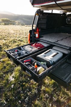 the back end of a truck with its cargo compartment open and tools in it's trunk