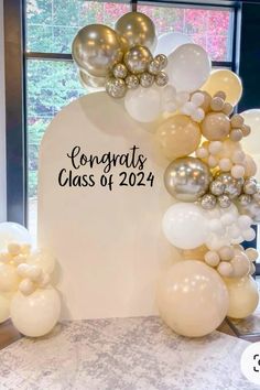 balloons and confetti are on display in front of a sign that says congrats class of 2021