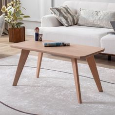 a living room with a white couch and wooden coffee table