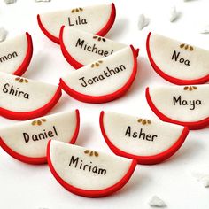 some red and white decorated cookies with names on them