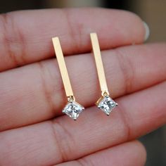 "Simple, elegant and stylish - these pair of earrings are a must have. Their versatility make them a keeper and absolutely to die for..! 0.33 ct Princess cut diamonds, dangling delicately from matt gold bar, worth a second glance! * Diamond Wt. : 0.65 Cts * Color-Clarity Grade : H-I, VVs-Vs * Gold - 14k, 2.45 gms yellow gold If you like this earring, please press \"Pin it\" button on the right of your screen. Find us on Instagram for exquisite designs: @abhikajewels Like us on Facebook: www.face Anniversary Long Drop Earrings, Modern Wedding Crystal Drop Earrings, Modern Crystal Drop Earrings For Wedding, Modern Diamond Dangle Earrings As Gift, Modern Diamond Dangle Earrings For Gift, Modern Dangle Diamond Earrings As Gift, Modern Dangle Diamond Earrings For Gift, Elegant Drop Linear Earrings As Gift, Elegant Linear Drop Earrings For Gift