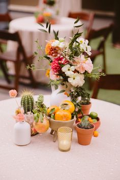 a table topped with lots of different types of flowers